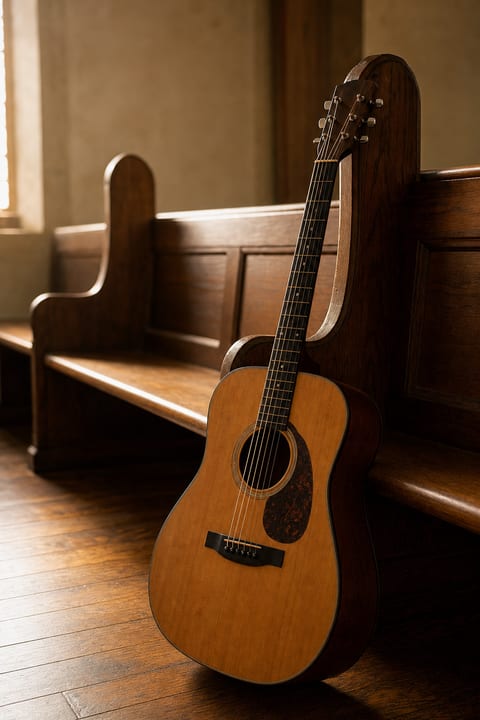Country church at dusk with a guitar on the front pew, evoking the connection between country songwriting and faith traditions.
